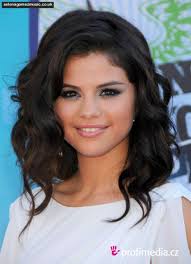 Lizzie has coal black hair, slightly curly, that hangs a little past her shoulders. Dark eyes. Medium build. Actually, the model on the cover of the book ... - Selena-Gomez1