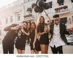 group of young people celebrating at a graduation party, dressed elegantly.の画像