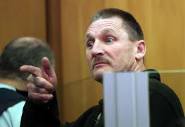 Ainsley Brent Anderson, 51, points towards the public gallery after appearing in court charged with being a party to the murder of Raymond Piper, Porirua. - ainsley_brent_anderson_51_points_towards_the_publi_4ca12eeb7a