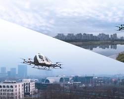 Image of early passenger airplane flying over a city.