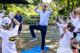 Prince Harry practicing yoga with goats