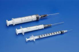 Three Plastic Disposable Syringes With A Needle On Blue ...