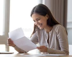 Image of student with a job offer letter, looking excited