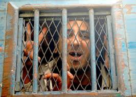 Abdel Kareem Nabil Suleiman looking out of a police bus after his trial in the port city of Alexandria, Egypt, on Jan. 25. (Photo: STR/AFP) - 0312Blogger