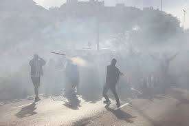 Police set off tear gas and fans lob objects at horses before Atletico v Arsenal