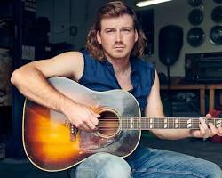 Image of Morgan Wallen performing live with a guitar