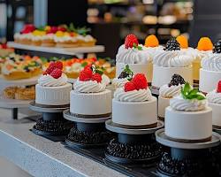 array of colorful cakes inside a display caseの画像