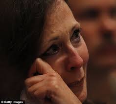 Tearful: A guest at the service becomes emotional as she listens to Ashley Fodor, the daughter of firefighter Edward Kilduff who was killed on September 11 - article-2036115-0DD1B24D00000578-672_470x423