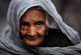 An elderly woman begs for alms on a roadside in the old part of New Delhi, India, Wednesday, Feb. 3, 2010. (AP Photo/Rajesh Kumar Singh) # - i28_21995649