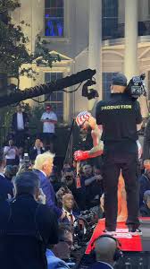 🇺🇸 Josh Hokit gifts Trump his chain at the White House UFC event. Respect and patriotism on full display. Trump at the Octagon with the fighters on the White House lawn. Moments like this hit different Writer: Oliver