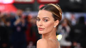 Margot Robbie and Dakota Johnson Embrace the Sheer Gown Trend