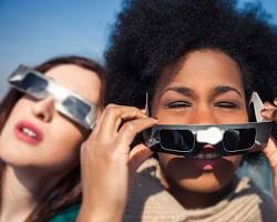 Image of people watching a solar eclipse with eclipse glasses