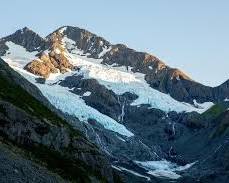 Image of majestic mountain range with a melting glacier at the peak