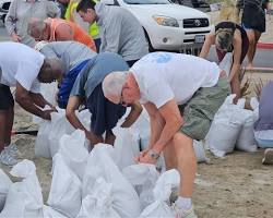 Image of people sandbagging their homes