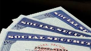 Older couple reviewing Social Security and Medicare documents at home