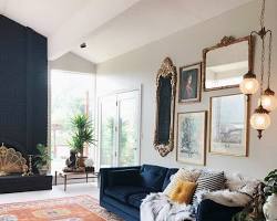 Image of living room with a blue rug and orange sofa