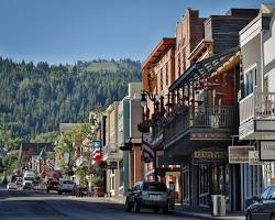 Image of Park City, Utah's historic main street with shops and restaurants, with ski slopes in the background