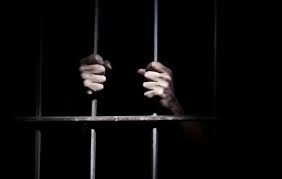 Image result for black man imprisoned behind bars