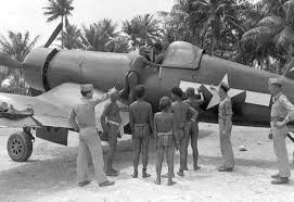 Pacific Islanders check out a Corsair on an Airstrip build ...