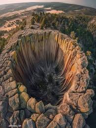 Buried - Devils Tower, located in the Black Hills of Wyoming, USA, rises dramatically from the surrounding landscape. Formed roughly 50 million years ago during a period of intense volcanic activity, it