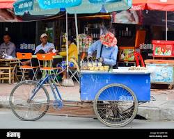 A friendly Cambodian street food vendor at his mobile cart