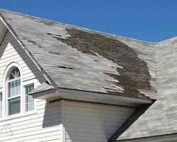 Image of house with a damaged roof