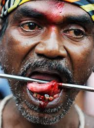 (Armend Nimani, AFP / Getty Images). An Indian Hindu devotee with his tongue pierced with a metal rod looks on, ... - slide_228905_1024944_free