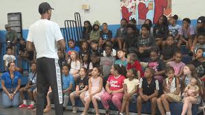 NBA all-star Ralph Sampson passes the ball to Lynchburg youth
