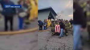A somber moment: Watch as a firefighter's body is removed from the fire in Searsmont, Maine