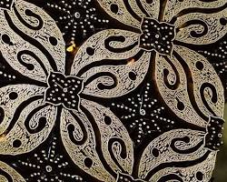 Colorful fabrics with patterns created using batik and block printing techniques.