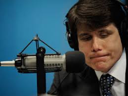 Rod Blagojevich listens to a caller while on the air with radio talk show host Cliff Kelly at WVON radio station in Chicago on Friday. - 090126_blago_barr_297
