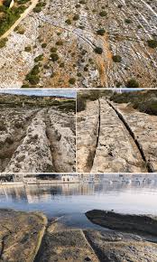 Cart ruts are a complex network of tracks carved in the rock across the Maltese Archipelago, with some disappearing over the cliffs or into the sea. The age and purpose of the
