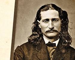 Image of Wild Bill Hickok, a legendary lawman of the American West, with his signature long hair and mustache, standing confidently with a revolver in his hand