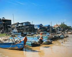 Image of Kompong Phluk floating village on Tonle Sap River, with stilt houses rising above the water