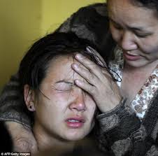 The daughter of Mount Everest avalanche victim Ang Kazi Sherpa cries while consoled by a relative as the body is brought to the Sherpa Monastery - article-2608478-1D3279F100000578-745_634x626