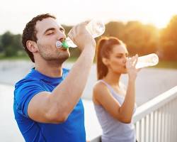 person drinking water before, during, and after a workout
