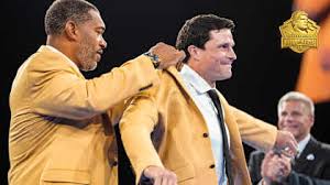 Luke Kuechly gets his gold jacket from Julius Peppers, bringing it full circle