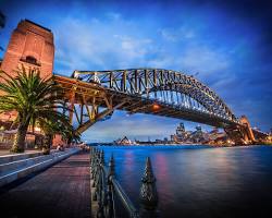 Sydney Harbour Bridge at night, with the city skyline in the background