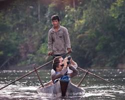 A local guide leading tourists on a trek in Cambodia.