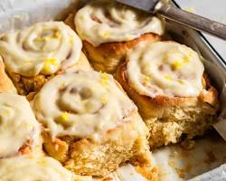 gluten free lemon rolls with yellow lemon icing sweet rolls, AI generated