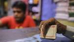 Photos: Indian rupee's fall breaks