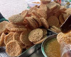 Gambar Intip, a thin, crispy cracker made from rice, with a golden brown color.