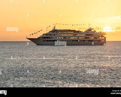 Image of cruise ship sailing towards a Hawaiian sunset