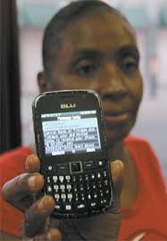 Joy Marchan shows the text she message she received yesterday notifying her to collect and cash a cheque at Central Bank, Port-of-Spain. - cat_0