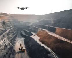 Gambar drone flying over an open pit mine