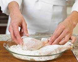 Image of Dredging chicken in flour mixture