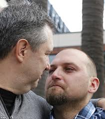 Robert Preece, left, and Robert Preece Jr., father and brother of Los Angeles Dodgers fan Jonathan Denver, embrace during a public plea for witnesses to ... - article-2437862-1861F6FD00000578-131_634x720