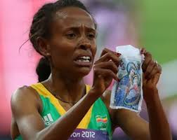 Meseret Defar of Ethiopia holds up a picture at the London 2012 Olympic Games on August 10, 2012 in London, England. Credit: Alexander Hassens/Getty Images ... - Meseret_Defar_of_Ethiopia_wins_gold_in_the_Womens_5000m_Final_Credit_Alexander_Hassenstein_Getty_Images_Sport_Getty_Images_CNA_US_Catholic_News_8_10_12