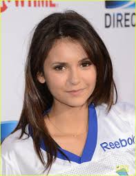 About this photo set: Nina Dobrev shows off her #22 jersey while attending the 2013 Celebrity Beach Bowl held at DTV SuperFan Stadium at Mardi Gras World on ... - ian-somerhalder-nina-dobrev-celebrity-beach-bowl-party-couple-07