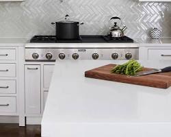 Herringbone pattern backsplash in white kitchen
